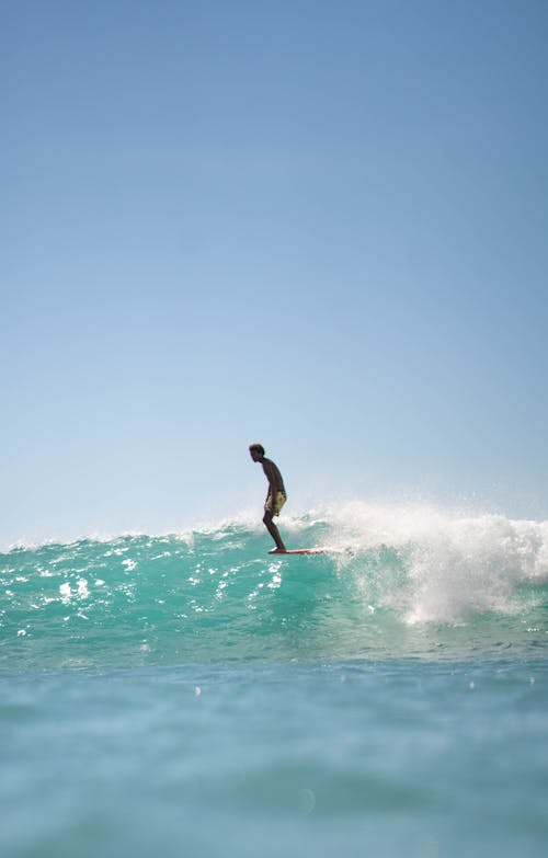 Photo Of Man Surfing On Ocean 