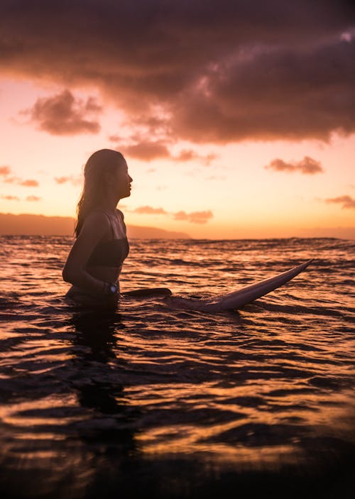 Photo Of Woman Riding Surfboard