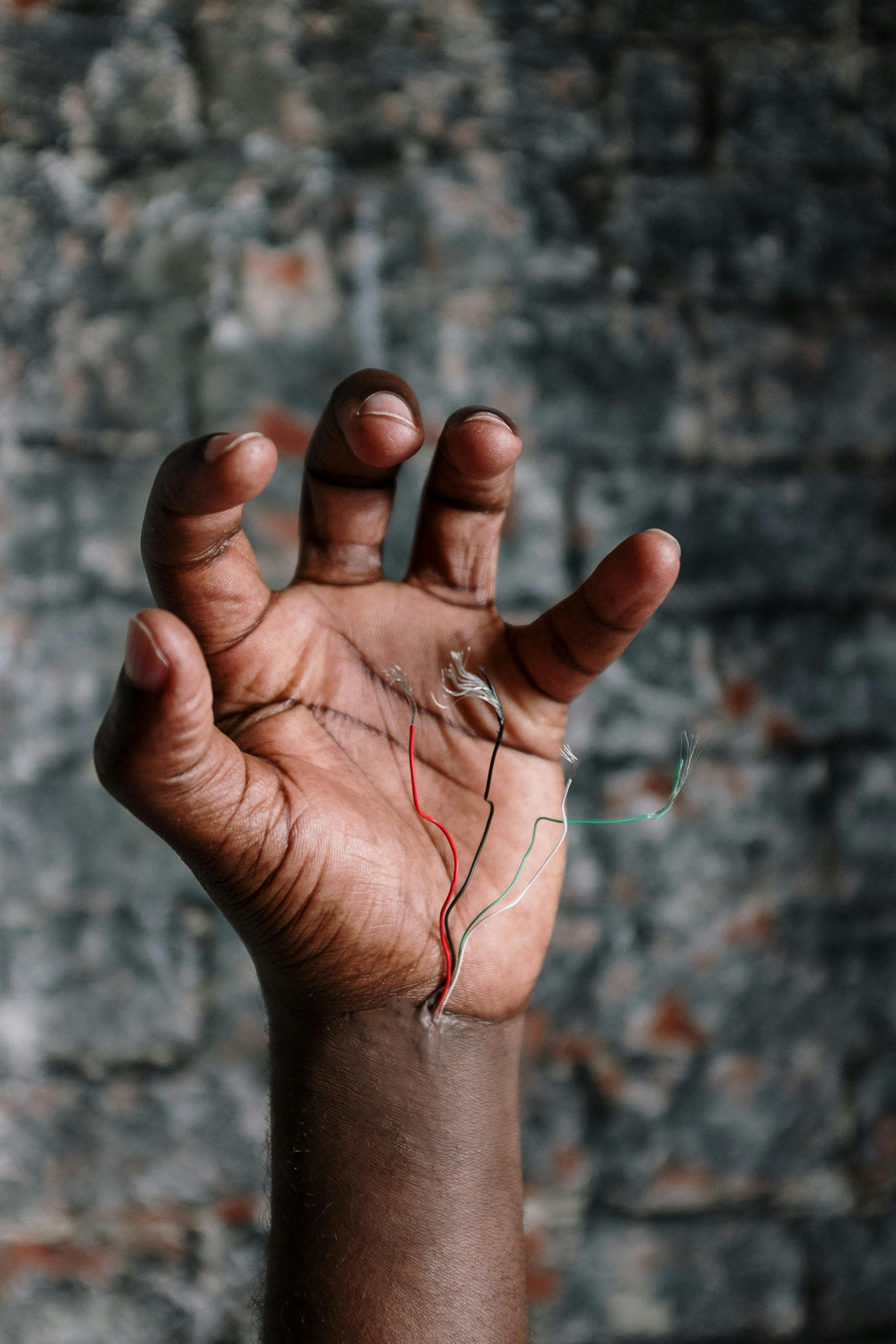 person holding silver pin on left hand