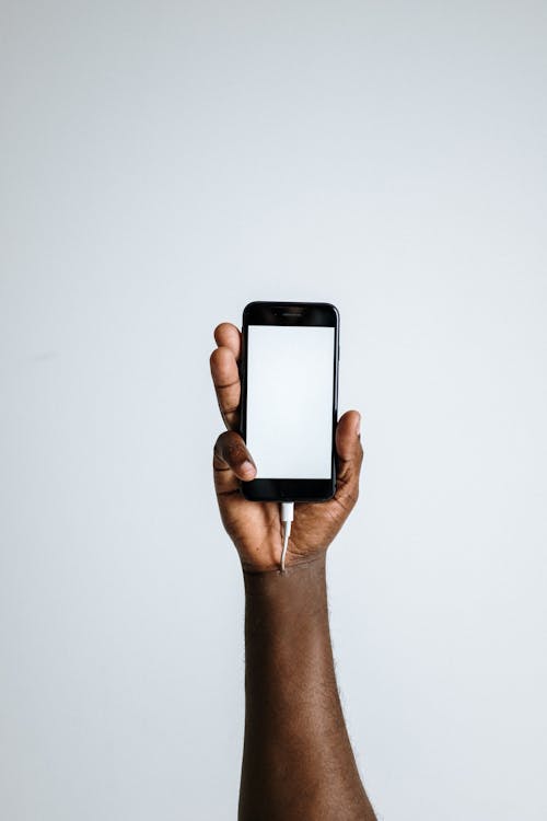 Free Photo Of Person Holding Smartphone Stock Photo