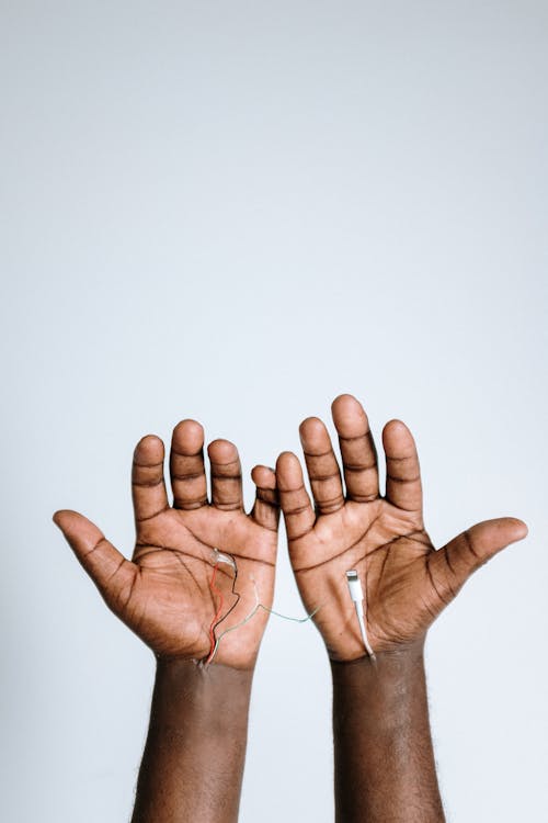 Photo Of Hands With Electric Wires And Cable