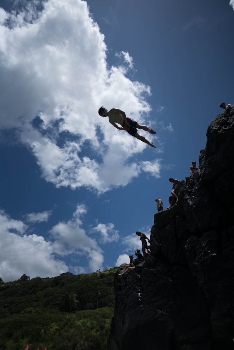 Man Diving From A Cliff