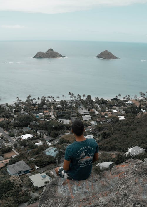 Photo Of Man Sitting On Edge Of Cliff