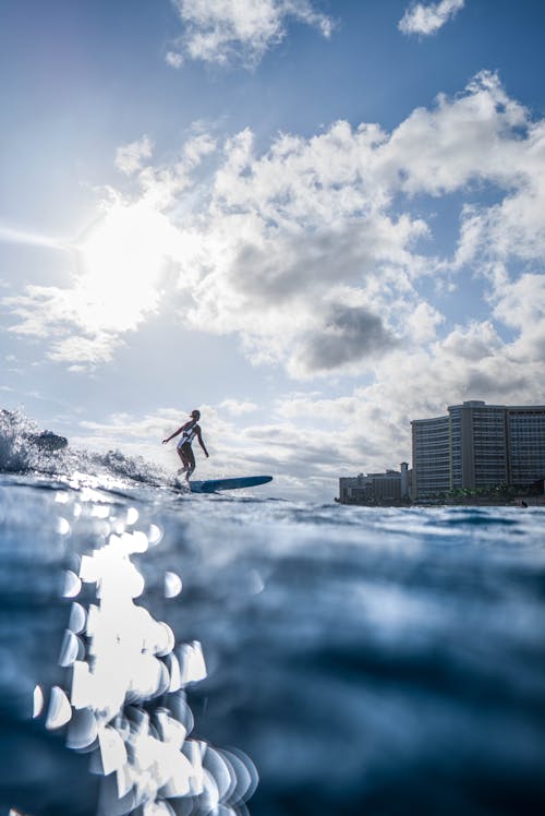 Photo Of Person Riding Surfboard