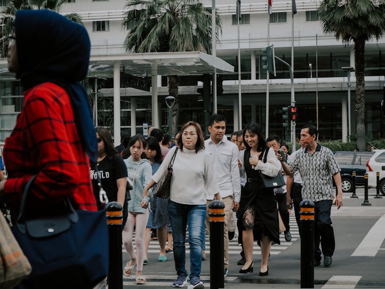 Group Of People Crossing The Pedestrian Lane