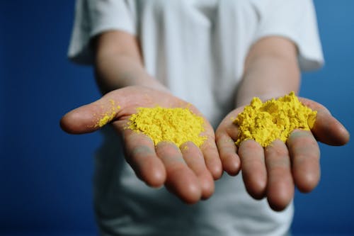 Photo Of Yellow Powder On Person's Hand