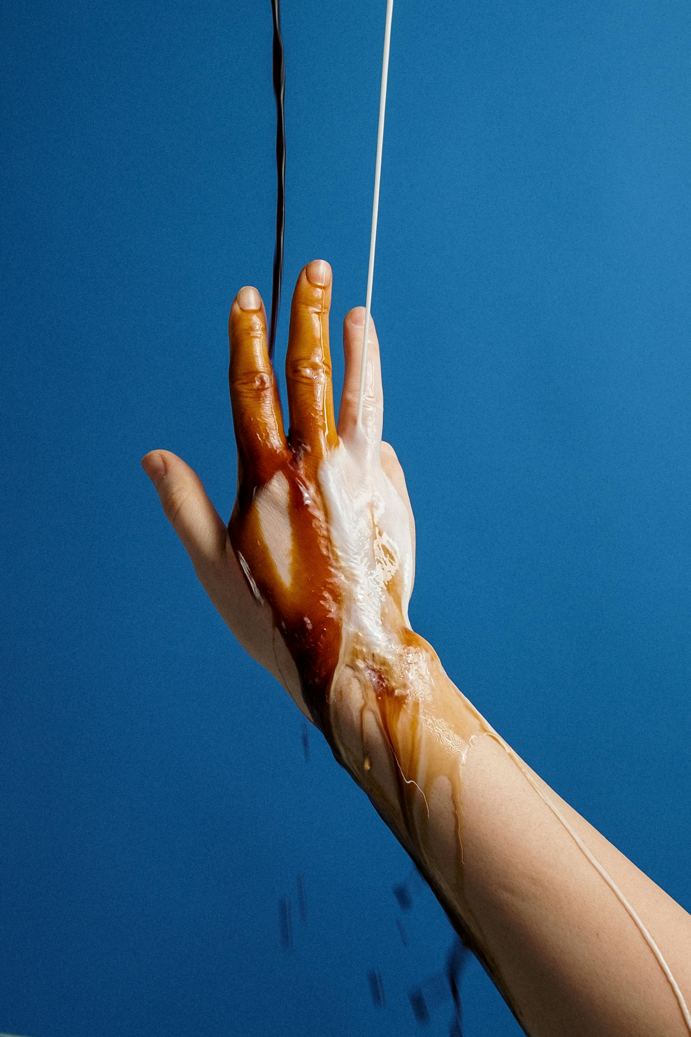 Photo Of Liquid Poured Into Person's Hand · Free Stock Photo