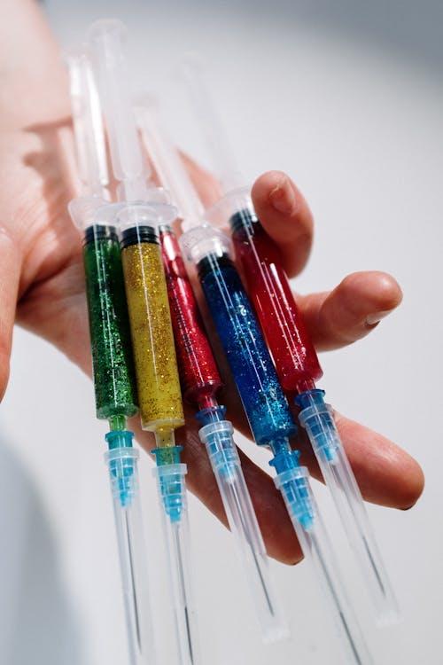 Close-Up Photo Of Person Holding Syringe