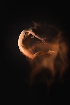 A surreal depiction of a dancer in motion using long exposure lighting, highlighting grace and flexibility.