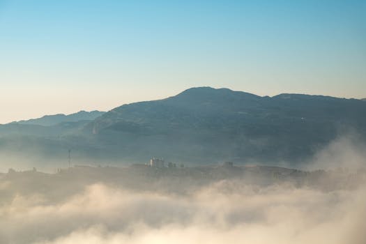 Capture of misty mountains and blue sky in Faraiya, Lebanon. Serene and captivating landscape.