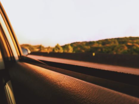 A peaceful car drive capturing the countryside at sunset, emphasizing freedom and travel.