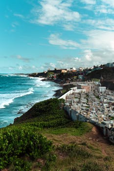 A stunning coastal view showing the juxtaposition of a cemetery and vibrant blue ocean in San Juan.