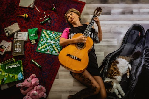 Photo Of Woman Holding Guitar