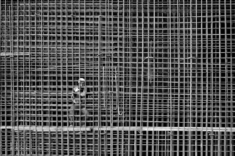 Man Working On Steel Bars Reinforcement In A Construction