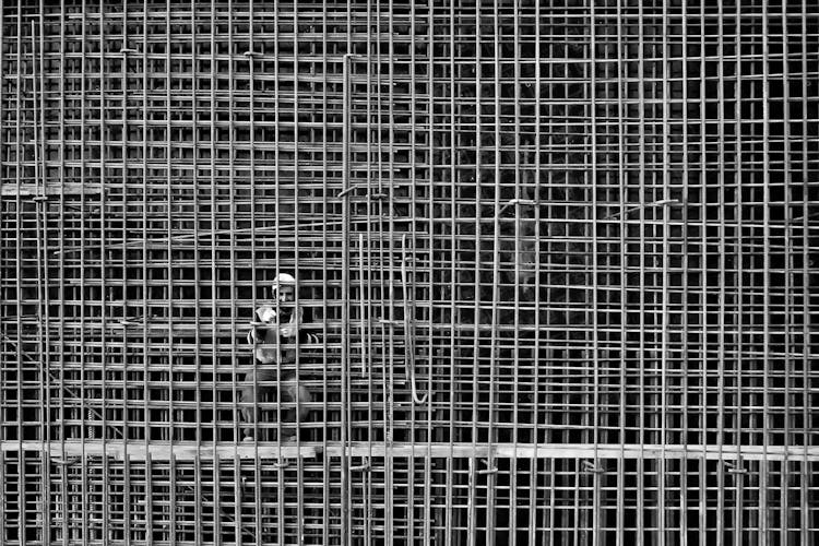 Man Working On Steel Bars Reinforcement In A Construction