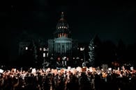 People Rallying in Front of White Building during Nightime