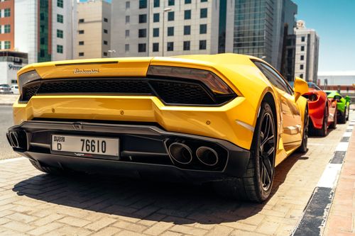 Free Stunning yellow Lamborghini sports car parked in downtown Dubai, showcasing luxury and speed. Stock Photo