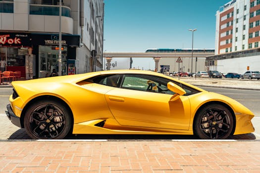 Sleek yellow sports car parked on a sunny day in the vibrant streets of Dubai.