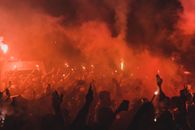 Expressive fans celebrating victory on street at night