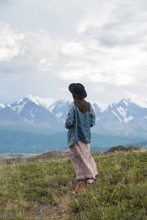 Woman Denim Jacket Standing on Green Grass Field · Free Stock Photo