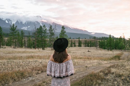 Woman Wearing a Black Hat Looking at Mountains 