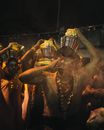 Anonymous ethnic Hindu people carrying pots of milk on head during traditional religious festival at night
