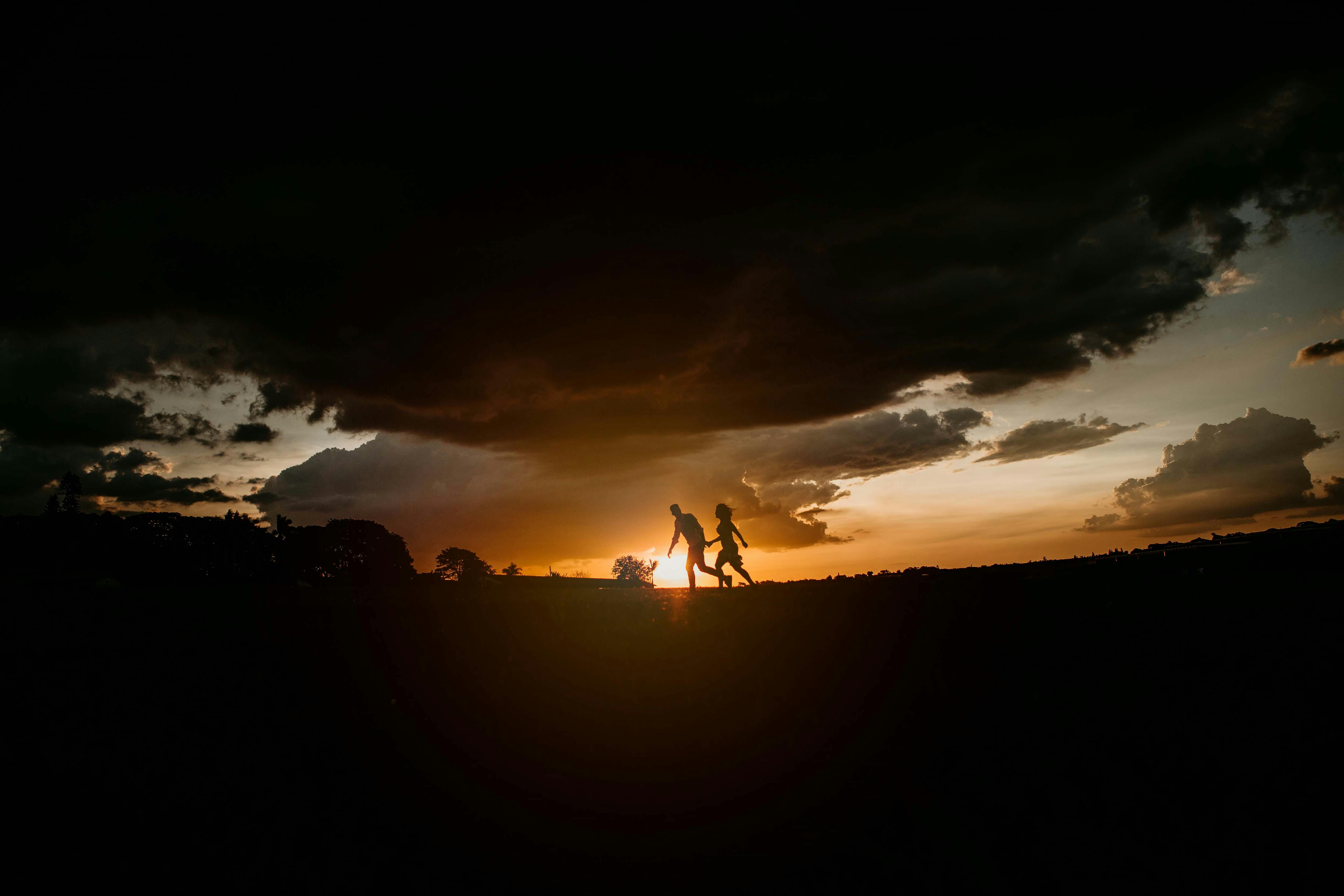 Silhouette of 2 Person Standing during Sunset · Free Stock Photo