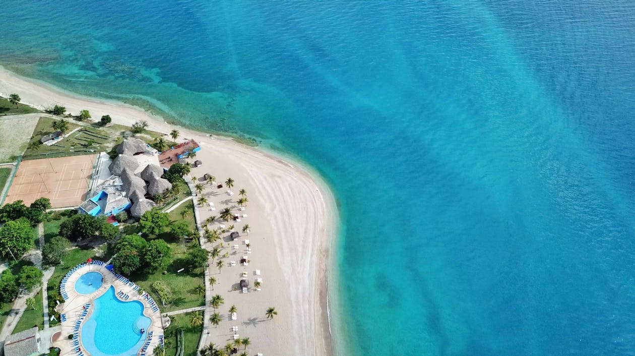 Idyllic Escape: Island in the Caribbean 4 A top view of a beach and a small island.