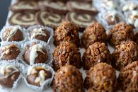 Energy balls and cookies on white plate on table