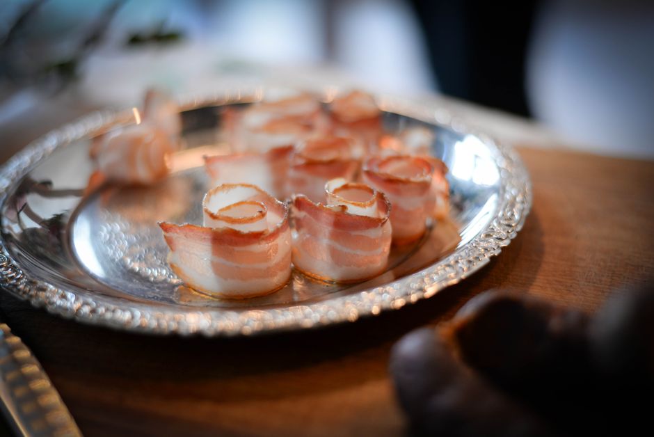 Sliced turkey bacon ranch pinwheels arranged on a white platter, showing the spiral of tortilla, ranch cream cheese, turkey, bacon, and lettuce.