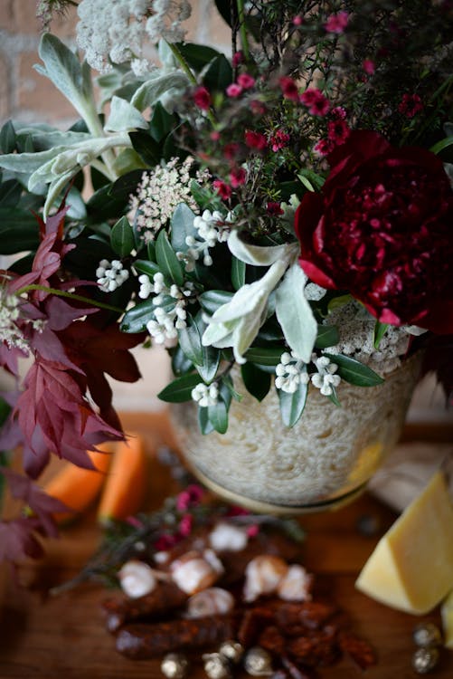 Elegant bouquet of flowers in vase near food · Free Stock Photo