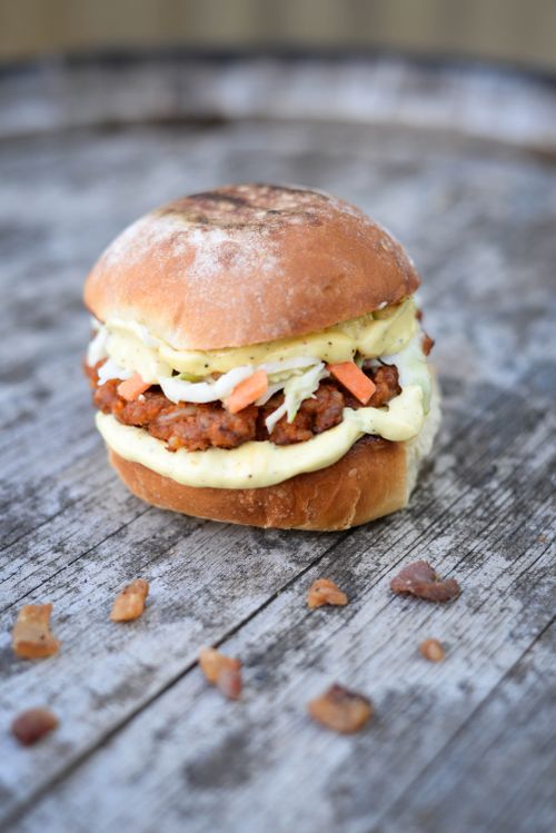 Free Fast food consisting of burger made on grill and served with small pieces of meat Stock Photo