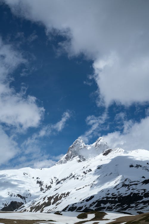 Snow Covered Mountain Under Blue Sky