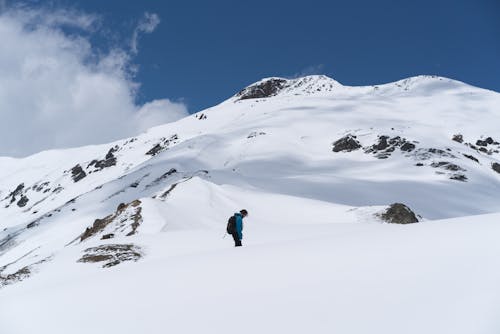 Free Man Hiking the Snowy Mountains Stock Photo