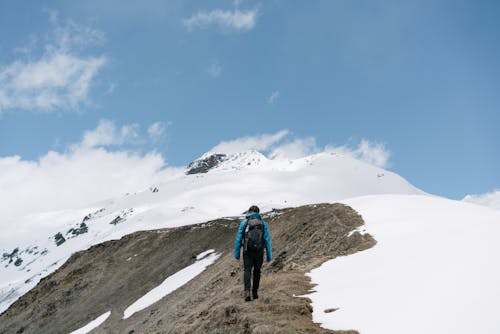 Man Hiking the Snowy Mountains