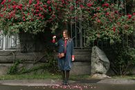 Girl in Blue Jacket Standing on Gray Concrete Pathway