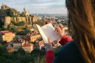 Photo of Person Holding Notebook and Pen
