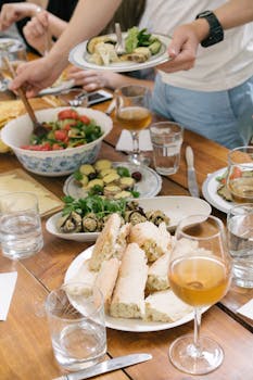 A table set with fresh salad, bread, and wine, creating a warm dining atmosphere.