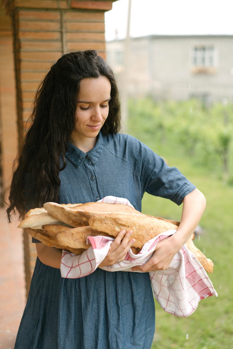 Photo Of Woman In Blue Dress Holding Baguette