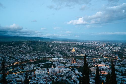 Free Stunning aerial view of Tbilisi, Georgia, showcasing the expansive urban landscape and distant hills. Stock Photo