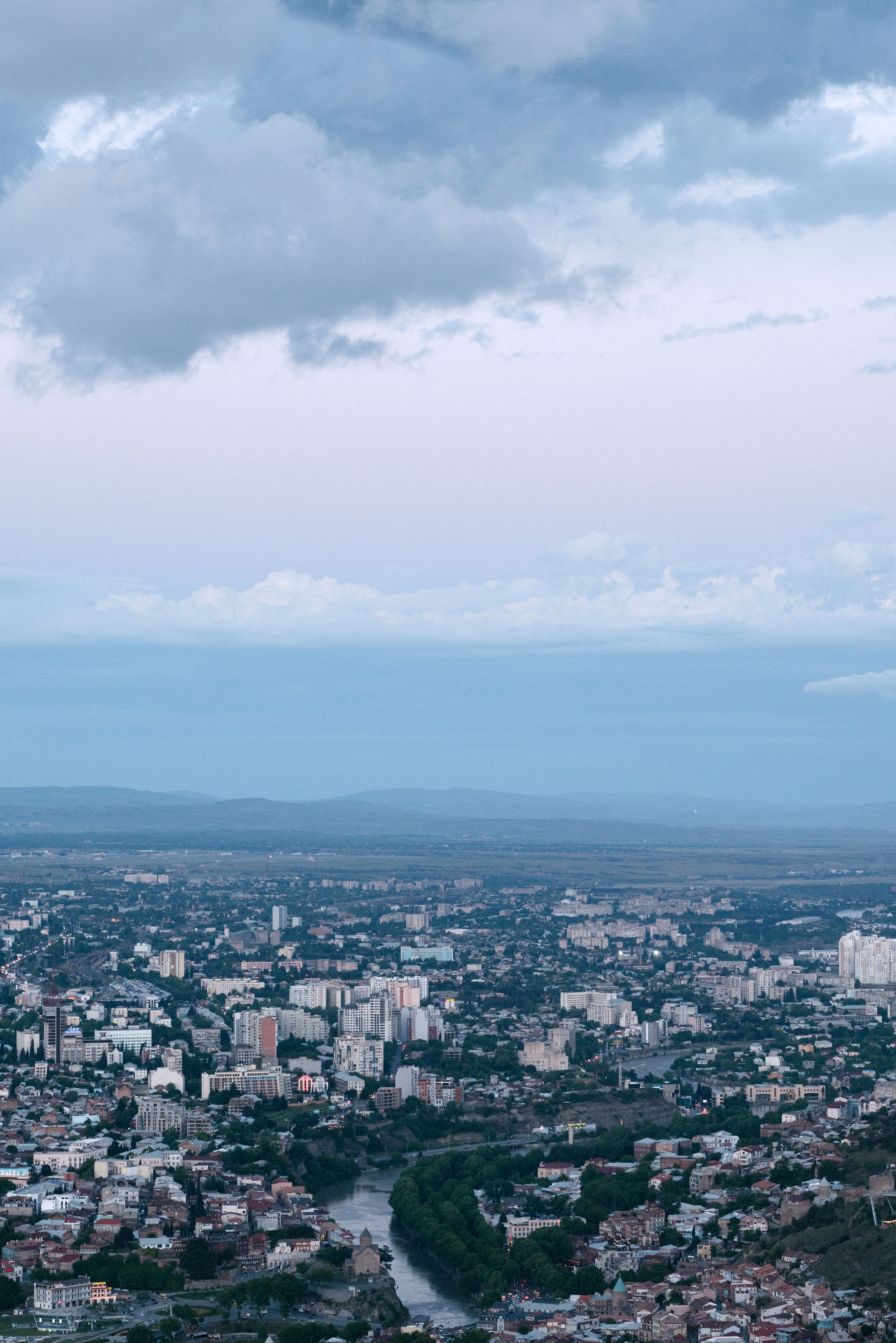 Aerial View of City Buildings Under Cloudy Sky · Free Stock Photo