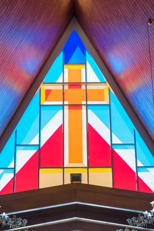 From inside view of bright multicolored leaded pane with yellow crucifix in center