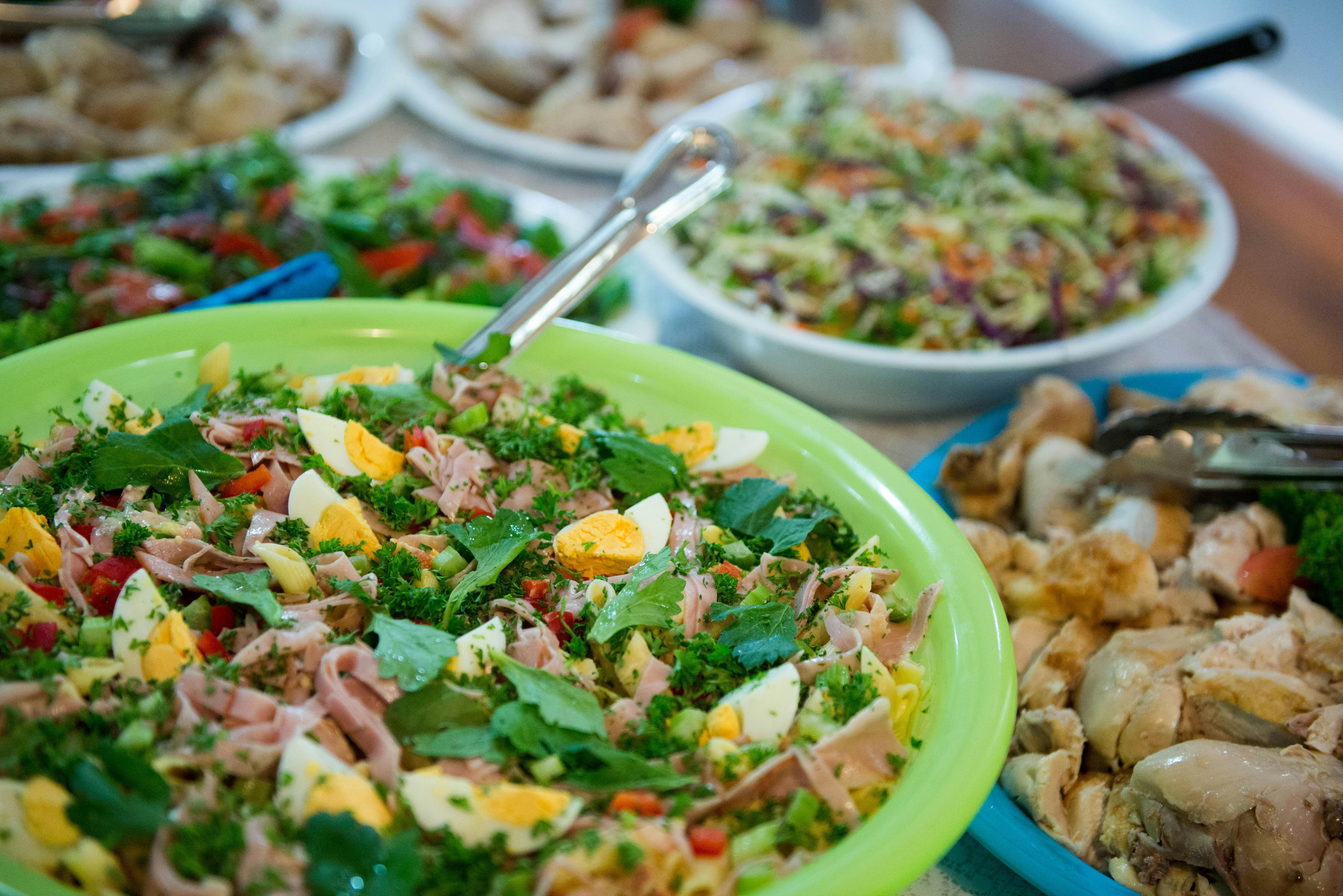 Festive table with assorted salads and dishes in bowls · Free Stock Photo