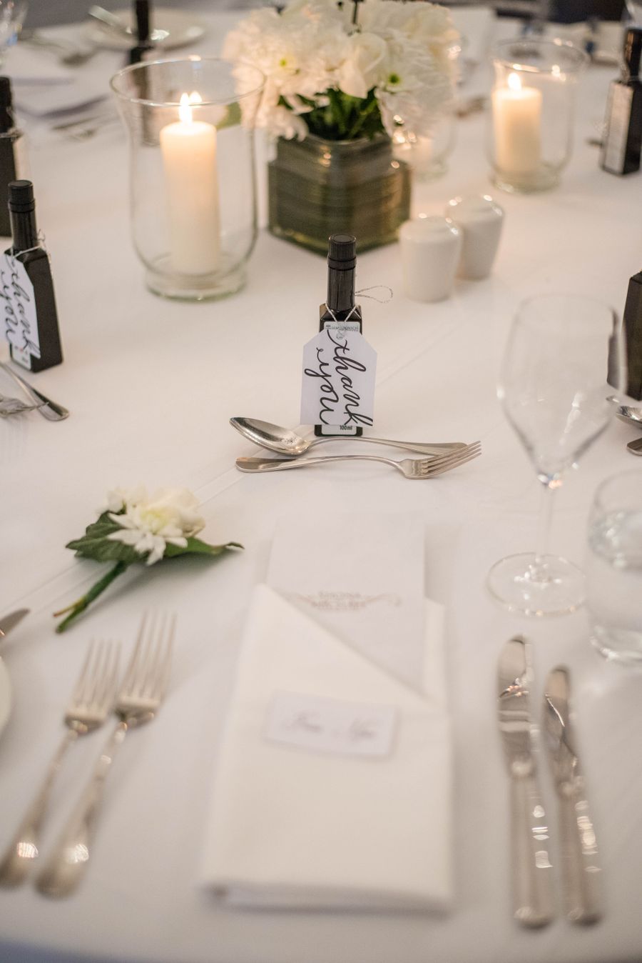 Banquet table set with white flowers and candles