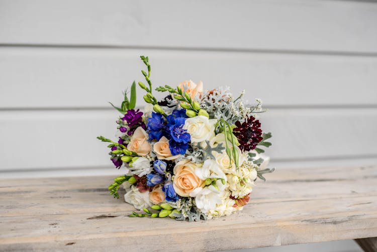 Colorful Bridal Bouquet On Wooden Table On Weeding Day