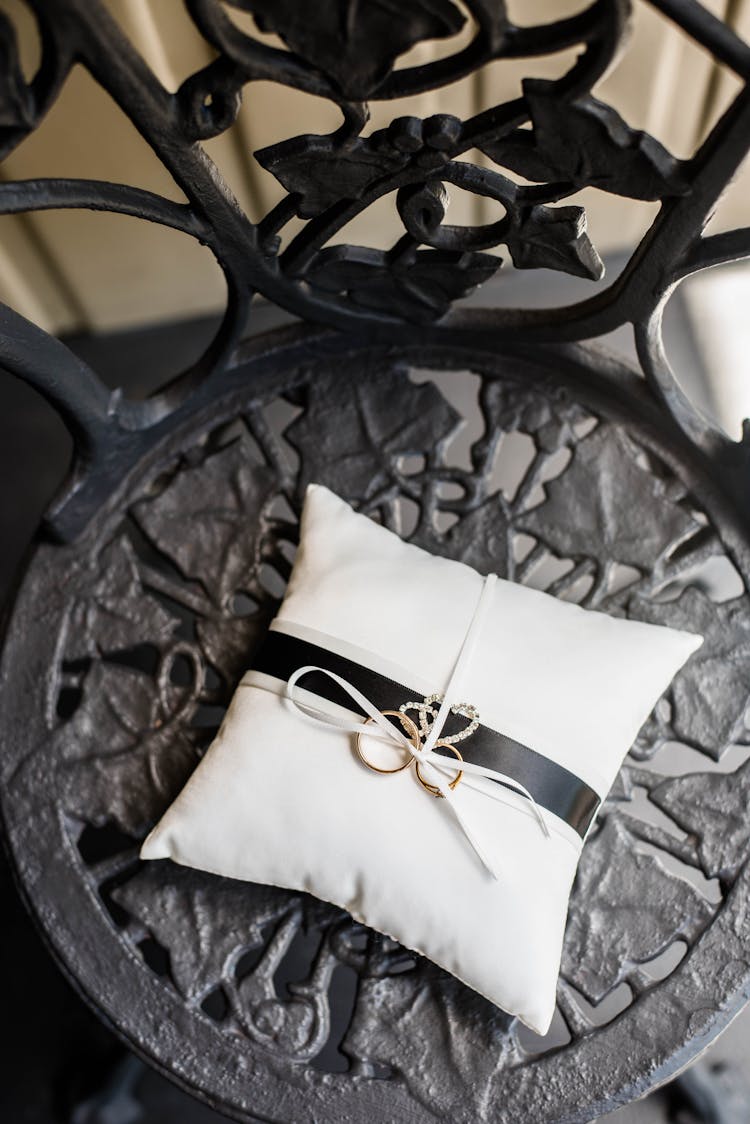 Pillow With Golden Rings On Ornamental Chair