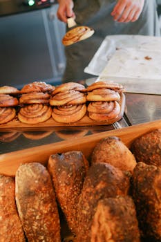 Delicious cinnamon rolls fresh from the oven, alongside crusty loaves of bread.