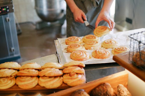 Person Preparing Bread on Tray