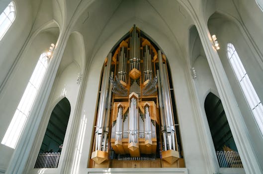 A stunning view of a large pipe organ inside a gothic cathedral, showcasing intricate design and religious architecture.