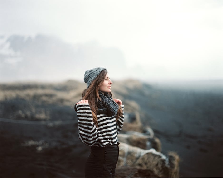 Woman in Black and White Striped Long Sleeve Shirt and Black Pants